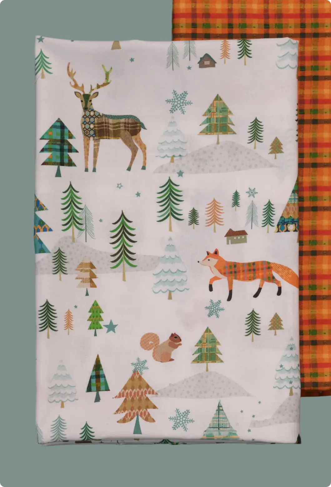 Woodland winter textile print with patterned deer, fox, squirrel, and plaid trees