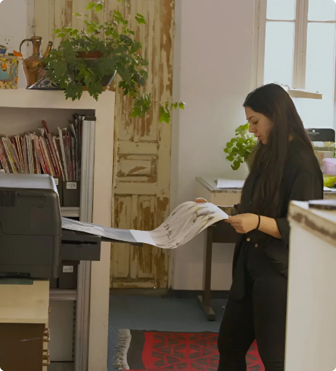 Designer reviewing prints in the studio
